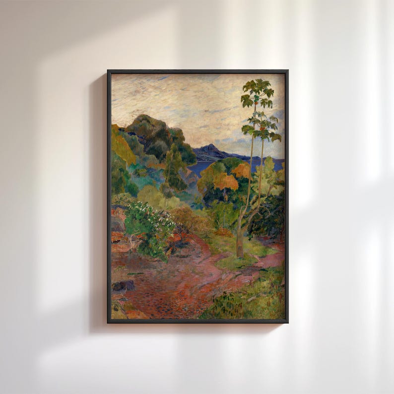 May include: Framed landscape painting with a vibrant color palette. The artwork depicts a path winding through lush greenery, with trees and foliage in shades of green, yellow, and orange. A mountain range is visible in the background, under a cloudy sky.