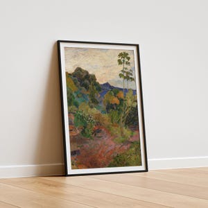May include: Framed art print of a landscape painting featuring a path winding through a lush, colorful forest. The artwork showcases a vibrant palette of greens, reds, and blues, with a mountain range in the background. The print is set in a black frame.