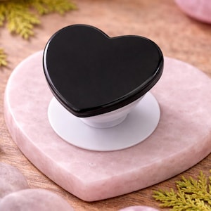 May include: A set of three ceramic mugs with a speckled, matte finish. The mugs are in shades of cream, light gray, and dark gray. Each mug has a simple, minimalist design, perfect for coffee or tea.