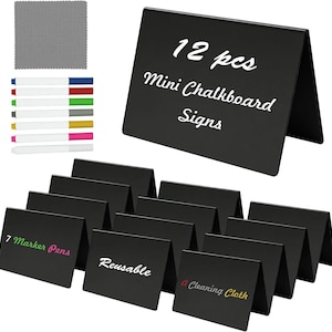 May include: A set of 12 black A-frame mini chalkboard signs, seven colored marker pens, and a gray cleaning cloth. The signs are rectangular and foldable. Text on the signs includes 12 pcs Mini Chalkboard Signs, 7 Marker Pens, Reusable, and A Cleaning Cloth.