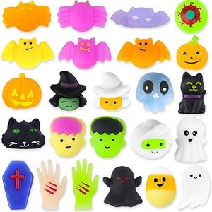 May include: A selection of colourful Halloween-themed toys, featuring bats, pumpkins, ghosts, and monster faces. The toys are in shades of orange, purple, yellow, and black. Some have smiling faces and spooky designs.