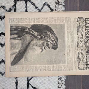May include: An antique copy of Harper's Weekly Journal of Civilization. The newspaper is open, displaying a detailed black and white illustration of a man with a beard and head covering. The text is visible.