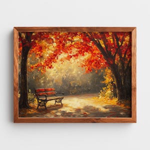 Puede incluir: Pintura enmarcada de una escena de parque otoñal. La obra representa un banco de parque bajo árboles con hojas rojas y naranjas vibrantes. La pintura tiene una paleta de colores cálidos y está enmarcada en madera.