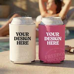 Op de afbeelding: Twee blikjeskoelers, één crèmekleurig en één roze, elk met de tekst "YOUR DESIGN HERE" in het wit. De crèmekleurige koeler staat links en de roze koeler rechts. De achtergrond toont een zwembad en een persoon.
