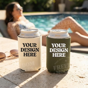 May include: Two beverage can coolers, one beige and one olive green, each holding a silver can. The coolers have the text "YOUR DESIGN HERE" in bold white letters. The background shows a pool and a person relaxing.