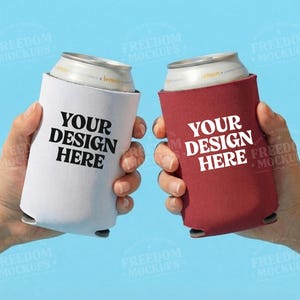 May include: Two beverage can coolers, one white and one burgundy, each held by a hand. The white cooler has the text "YOUR DESIGN HERE" in bold black letters. The burgundy cooler also has the same text in white.