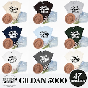 May include: Nine mockups of Gildan 5000 t-shirts in various colors, each paired with denim shorts and a brown fedora hat. The shirts have the text "YOUR DESIGN HERE" printed on them. Floral accents are also included.
