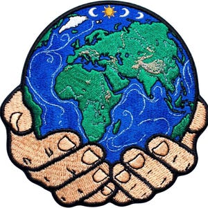 May include: Embroidered patch featuring a blue and green globe held in two tan hands. The globe shows continents and oceans, with a sun, moon, and cloud in the upper portion. The patch has a black border.