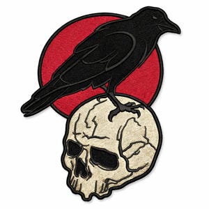 May include: Embroidered patch featuring a black crow perched atop a skull. The skull is off-white with detailed shading, set against a red circular background. The crow is detailed with black thread.