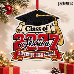 May include: A graduation ornament featuring a black mortarboard cap with a yellow tassel, a banner reading Class of, the year 2027 in red, the name Jessica in black script, and a red banner with the text RIVERSIDE HIGH SCHOOL.