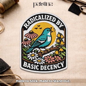 May include: Embroidered patch with a blue bird perched on a branch, surrounded by flowers. The patch features the text "RADICALIZED BY BASIC DECENCY" in a black and white design. The patch is made to stick.