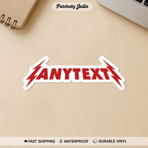 May include: A white sticker with the red text "ANYTEXT" in a stylized font, flanked by red lightning bolt designs. The sticker is on a light brown surface. The text "FAST SHIPPING", "WATERPROOF", and "DURABLE VINYL" are at the bottom.