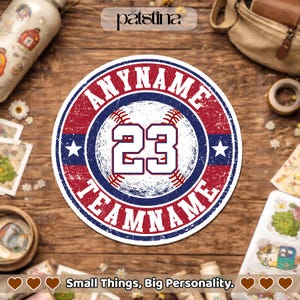 May include: A round baseball-themed sticker with the text "ANYNAME TEAMNAME" in a distressed red font. The number "23" is in the center, with a baseball design. The sticker has a blue and white border and two stars. The text "Small Things, Big Personality" is at the bottom.