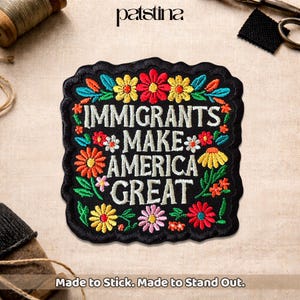 May include: Black embroidered patch with the words "IMMIGRANTS MAKE AMERICA GREAT" in white, surrounded by colorful flowers and leaves. The patch has a black border and the text "Made to Stick. Made to Stand Out."