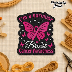 May include: Embroidered patch with the text "I'm a survivor" and "Breast Cancer Awareness". The patch features a pink ribbon shaped like a butterfly on a black background, with pink butterflies and white stars.