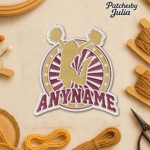 May include: Embroidered patch featuring a cheerleader in mid-air with pom-poms. The design includes a gold cheerleader silhouette, a burgundy and gold circular border, and the text "ANYNAME". The patch is surrounded by gold thread and the text "Patchesby Julia".