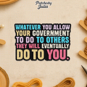 May include: Embroidered patch with the text "WHATEVER YOU ALLOW YOUR GOVERNMENT TO DO TO OTHERS THEY WILL EVENTUALLY DO TO YOU." The text is in various colors on a black background. The patch is on a beige fabric.
