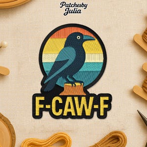 May include: Embroidered patch featuring a dark blue crow perched on a tree stump, set against a circular background with horizontal stripes of orange, yellow, and teal. The text "F-CAW-F" is below the crow.