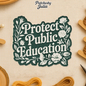 May include: A dark green embroidered patch with the words "Protect Public Education" in white script, surrounded by floral and leaf designs. The patch is on a beige fabric background, with the maker's name, "Patchesby Julia," at the top.