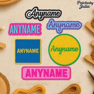 May include: A selection of embroidered patches, each displaying the word "Anyname". The patches come in diverse shapes and colours, including pink, blue, yellow, and green, with contrasting border colours. These patches are designed for customisation.