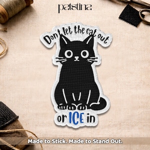 May include: Embroidered patch featuring a black cat with large eyes and white whiskers. The patch reads "Don't let the cat out or ICE in." The text "Made to Stick. Made to Stand Out." is at the bottom.