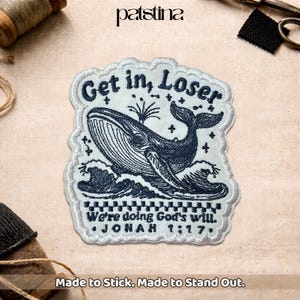 May include: Embroidered patch featuring a whale design with the text "Get in, Loser" and "We're doing God's will. Jonah 1:17." The patch is white with navy blue details. The patch is made to stick and stand out.