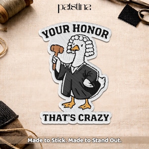 May include: Embroidered patch featuring a cartoon duck dressed as a judge, holding a gavel. The patch reads "YOUR HONOR" above the duck and "THAT'S CRAZY" below. The patch is white with black, brown, and yellow accents.