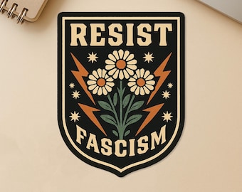 May include: Black and beige sticker with the words "RESIST FASCISM" in a shield shape. The design includes three daisies, lightning bolts, and stars. The sticker is waterproof and made of durable vinyl.