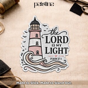 May include: Embroidered patch featuring a lighthouse with pink and white stripes, the text "the LORD IS MY LIGHT" and "PSALM 27:1". The patch has a wave design at the bottom and the text "Made to Stick. Made to Stand Out."