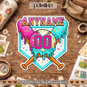 May include: A colorful baseball-themed sticker with the text "ANYNAME" at the top. The design features a baseball with the number "00" and crossed bats, all set against a light blue background. The baseball is decorated with pink and blue ice cream drips and sprinkles. The sticker also has the text "Small Things, Big Personality."