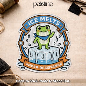 May include: Embroidered patch featuring a green frog wearing a blue bandana, standing on a melting ice cube. The patch has the text "ICE MELTS" and "UNDER RESISTANCE" in a blue and orange design. The patch is made to stick.