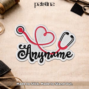 May include: Embroidered patch featuring a stethoscope design with a heart shape and the word "Anyname" in black script. The stethoscope is red and black, with a white background. The text "Made to Stick. Made to Stand Out." is at the bottom.