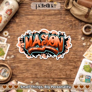 May include: An orange and black sticker with the name "MASON" in graffiti style. The sticker has a white border and is surrounded by black paint splatters. The text "Small Things, Big Personality" is at the bottom.