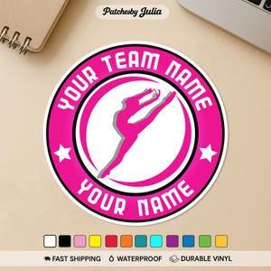 May include: A round, hot pink sticker with the text "YOUR TEAM NAME" and "YOUR NAME" in white. The sticker features a dancer in a split leap inside a white circle. Two white stars are on the sticker. The sticker is waterproof and made of durable vinyl.