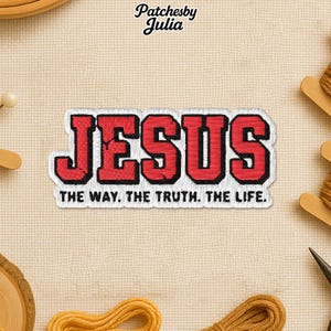 May include: Embroidered patch featuring the word "JESUS" in red block letters with a black outline. The phrase "THE WAY. THE TRUTH. THE LIFE." is below. The patch is set against a cream-coloured fabric. The brand name "Patchesby Julia" is at the top.
