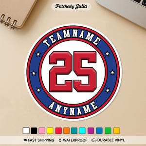 May include: A round sticker with a red and blue design. The sticker features the number 25 in red, surrounded by a blue ring with white stars. The words TEAMNAME and ANYNAME are printed on the sticker.