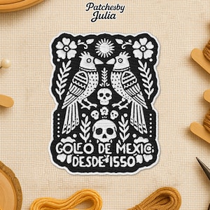May include: Black and white embroidered patch featuring two birds facing each other, a sun, flowers, and skulls. The patch has the text "GOLEO DE MEXIC" and "DESDE 1550". The brand name "Patchesby Julia" is at the top.