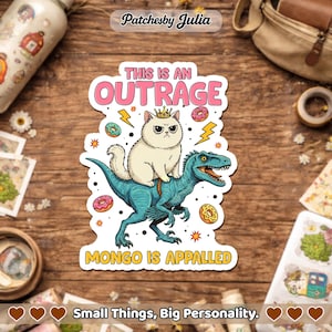 May include: A sticker featuring a grumpy cat wearing a crown riding a teal dinosaur, surrounded by donuts and lightning bolts. Text reads "THIS IS AN OUTRAGE" and "MONGO IS APPALLED". The sticker is from "Patchesby Julia".