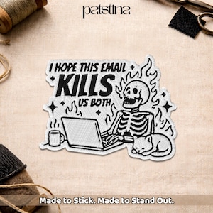 May include: Embroidered patch featuring a skeleton working on a laptop, with a cat, coffee mug, and flames. The text reads "I HOPE THIS EMAIL KILLS US BOTH." The patch is white with black details.
