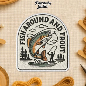 May include: Embroidered patch with the text "FISH AROUND AND TROUT." The patch features a leaping trout, a fisherman, trees, and clouds. The patch is white with black, green, and orange details. The brand name "Patchesby Julia" is at the top.
