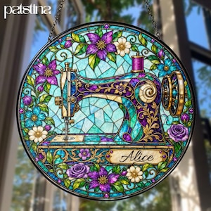 May include: A circular stained glass suncatcher featuring a sewing machine design in shades of purple, teal, and blue. The piece is surrounded by floral motifs and includes a rectangular plaque with the name Alice printed in black script text.