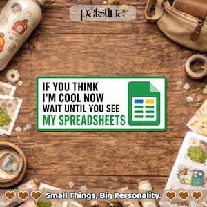 May include: A green and white sticker with the text "IF YOU THINK I'M COOL NOW WAIT UNTIL YOU SEE MY SPREADSHEETS" and a spreadsheet icon. The sticker is on a wooden surface with other items.