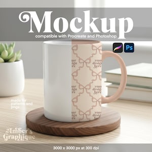 May include: A white ceramic mug with a peach-colored handle and interior, featuring a bow pattern on one side. The mug sits on a wooden coaster. Text on the mug reads "your design here" and "Mockup". The image is a mockup compatible with Procreate and Photoshop.