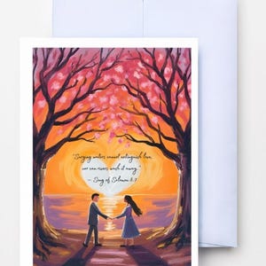 May include: A greeting card depicting a couple holding hands beneath a sunset, with the quote "Surging waters cannot extinguish love, nor can rivers wash it away - Song of Solomon 8:7". The card is set against a backdrop of trees and a light blue envelope.