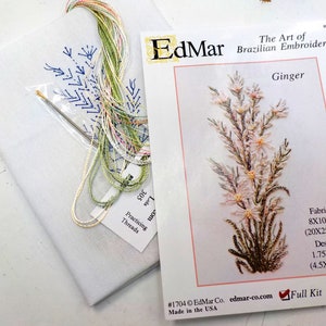 May include: A white fabric embroidery kit with a floral design, needle, and colorful threads. The kit includes a printed card with the text "Ginger" and "The Art of Brazilian Embroidery." The fabric measures 8x10 inches.
