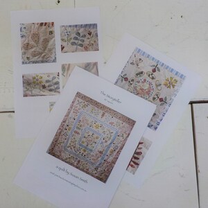 May include: A quilt pattern called "The Storyteller" by Susan Smith. The pattern is for a quilt with 87 squares. The quilt is made of white fabric with blue and pink floral embroidery. The pattern is available for purchase on the website patchworkandquiltingbythesea.com.au.