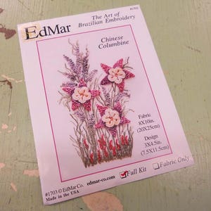 May include: A pink and white embroidered Chinese Columbine flower design pattern. The pattern is 3 x 4.5 inches (7.5 x 11.5 cm) and is available as a full kit or fabric only. The pattern is from EdMar Co. and is made in the USA.