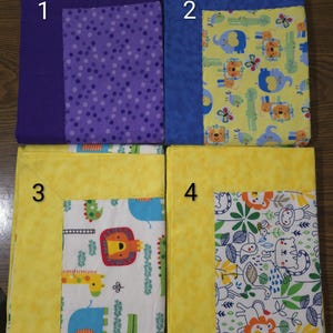 May include: Four baby blankets with different patterns. The top left blanket is purple with a purple polka dot pattern. The top right blanket is blue with a yellow animal print. The bottom left blanket is yellow with an animal print. The bottom right blanket is yellow with a jungle animal print.