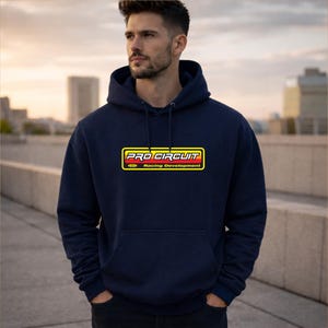 May include: Navy blue hoodie with a front pocket and a yellow, red, and white "PRO CIRCUIT Racing Development" logo. The sweatshirt has a drawstring hood and is made of a soft material.