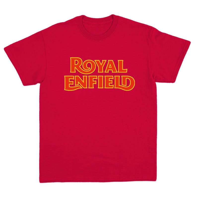 May include: A bright red short-sleeved t-shirt featuring the text ROYAL ENFIELD printed across the chest in a bold, stylized yellow font with a thin orange outline. The garment has a crew neckline and a standard fit with short sleeves.